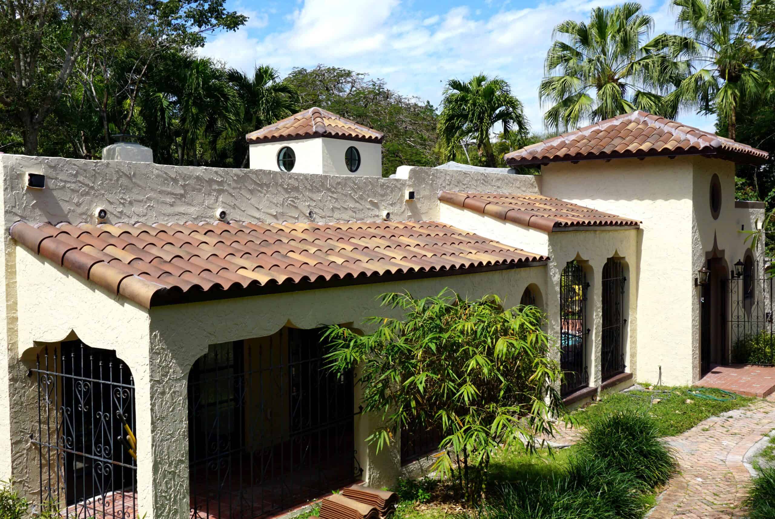 Spanish Revival home with red clay roof tiles and white stucco walls