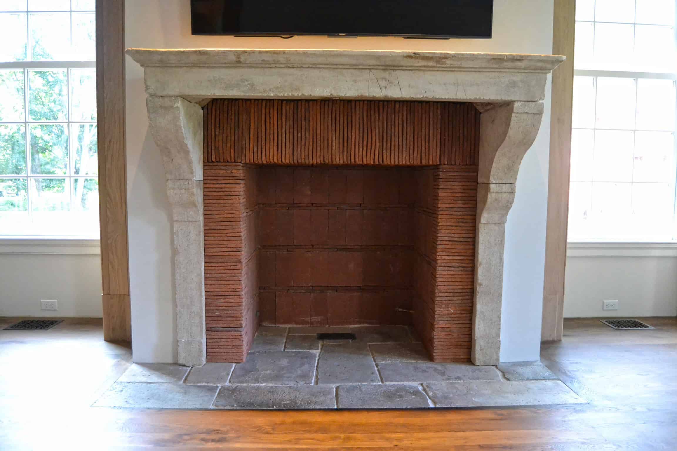 Clay tiles used as a fireplace surround. Designed by John Toates Architecture & Design LLC