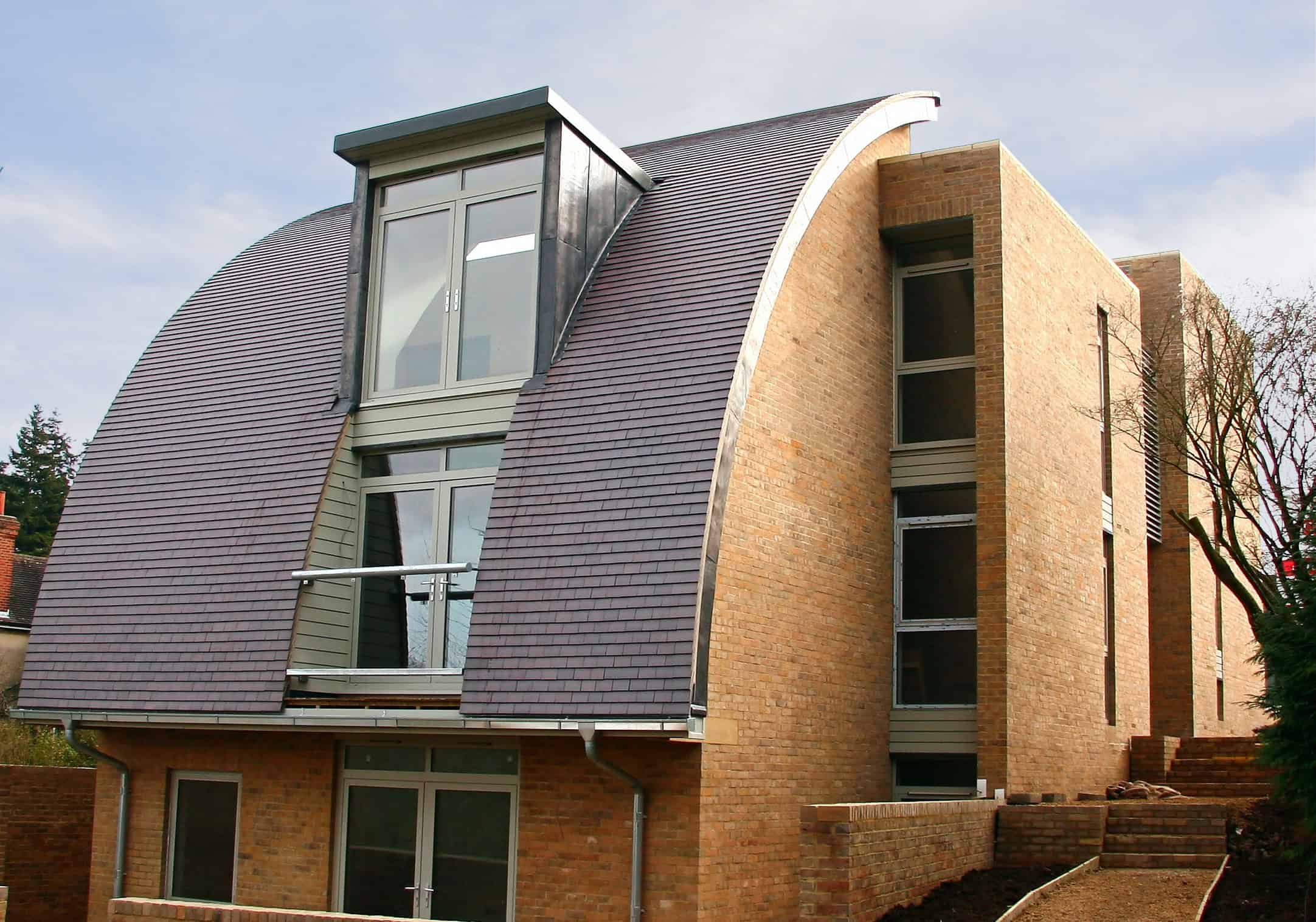 Blue Brindle Tiles Used On A Modern Curved Roof
