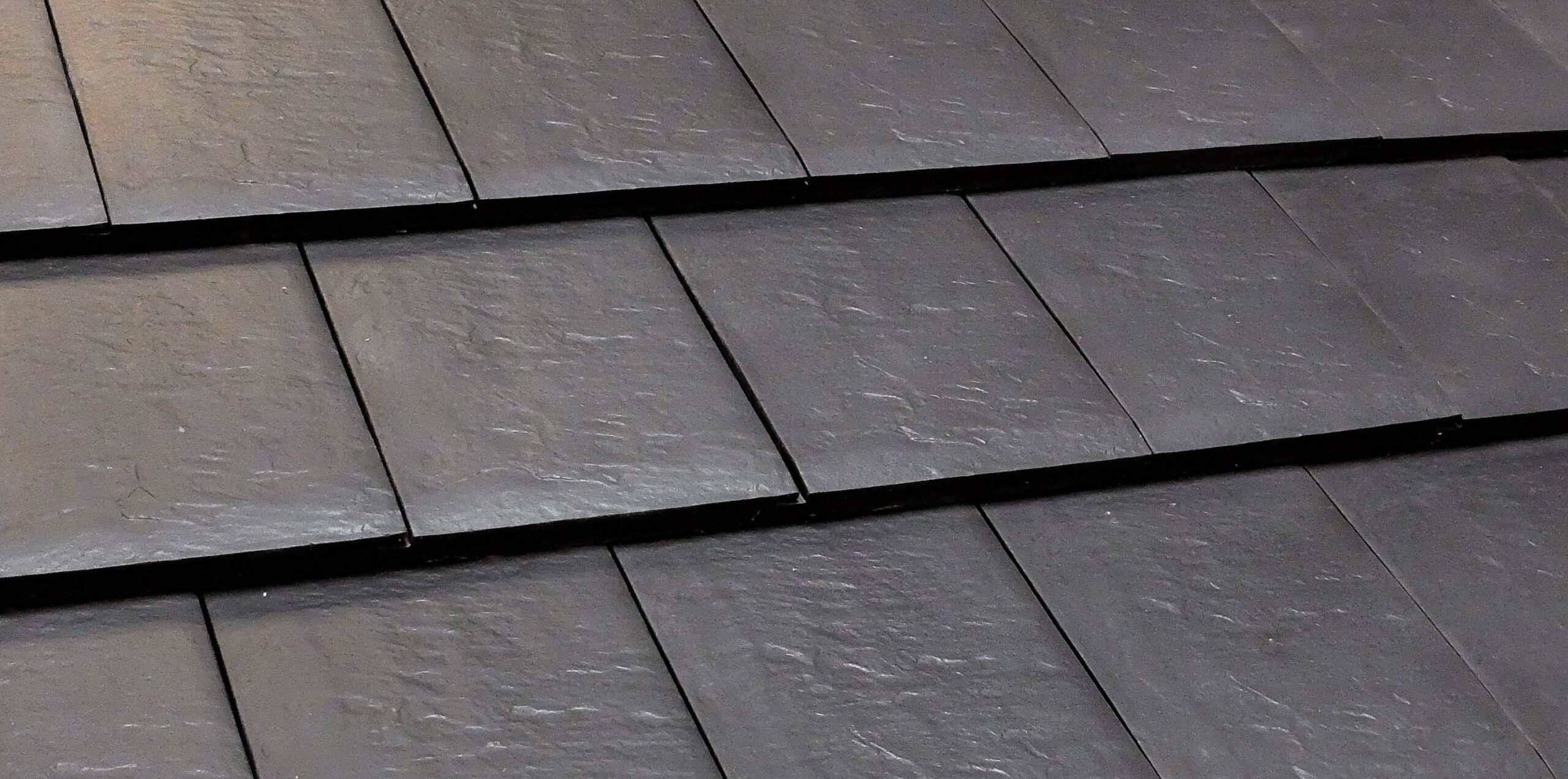 Verea Flat Interlocking in Textured Slate Close-up of gray flat clay roof tiles in straight shingle pattern
