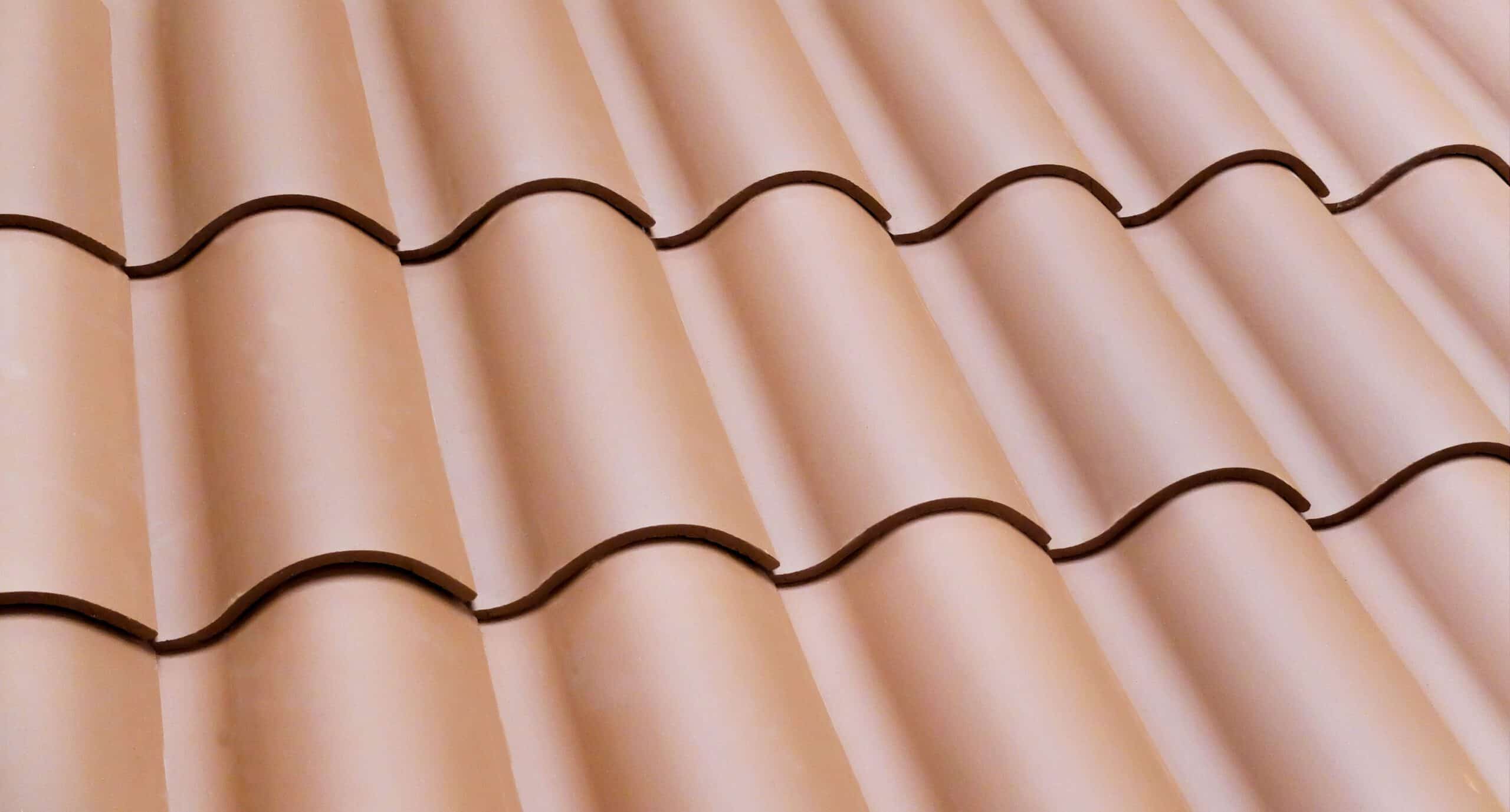 Close-up of red pan and cover clay roof tiles in wave pattern - Verea Spanish S in Ohio Red Blend
