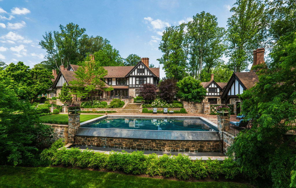 Large Tudor-style estate with clay roof tiles and landscaped pool area. House designed by Peter Zimmerman Architects - Clay tiles from Northern Roof Tiles