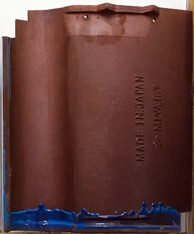 Back of reclaimed clay roof tile showing nibs and maker stamp